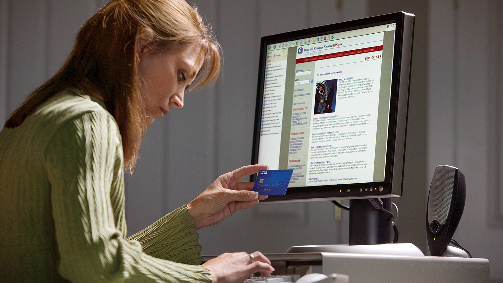 A woman sitting at her computer, utilizing secure payment options to ensure the safety and security of her online transactions. 